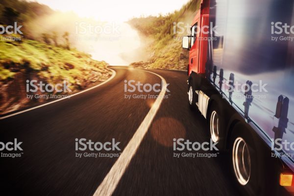 Truck on road in a natural landscape
