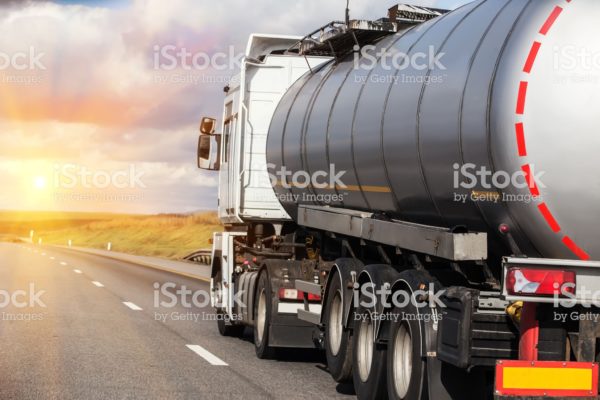 Big gas-tank goes on highway against the sky