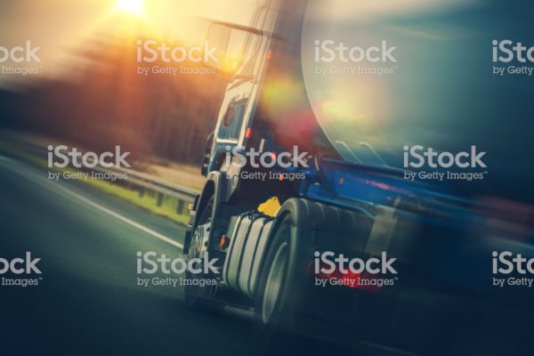 Fuel Tanker Truck on the Road. Modern Land Transportation Theme. Semi Truck Vehicle.